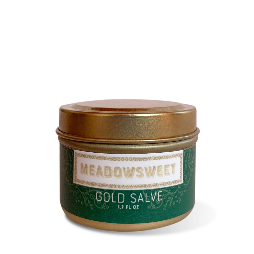 A gold metal jar containing Meadowsweet Gold Salve.