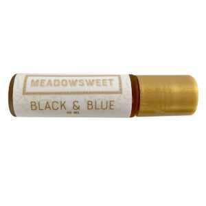A small cylider with a gold lid and white label containing Black & Blue Balm.