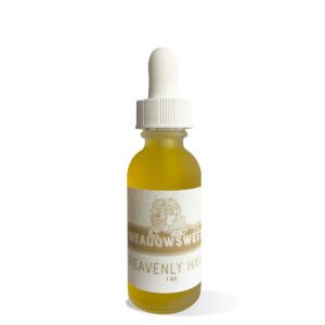 Frosted glass dropper bottle containing Heavenly Hair Oil.