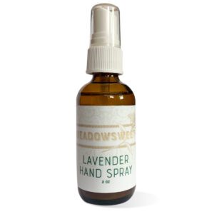 a clear hand spray in a brown glass spray bottle with a white spray