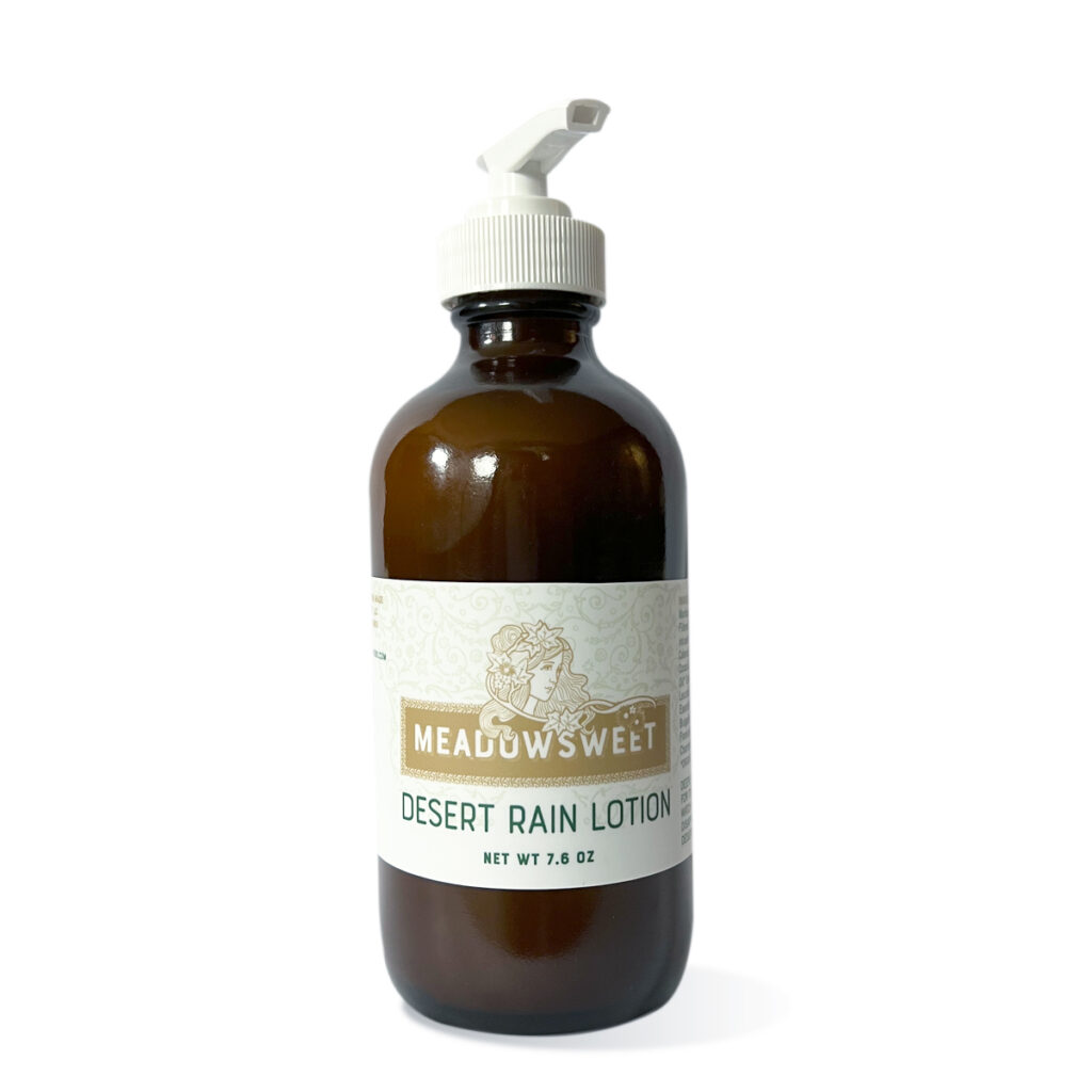 A large brown glass lotion pump bottle contains Desert Rain Lotion
